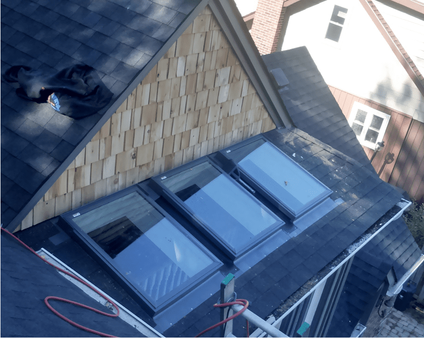 Roof with skylights and wooden siding.